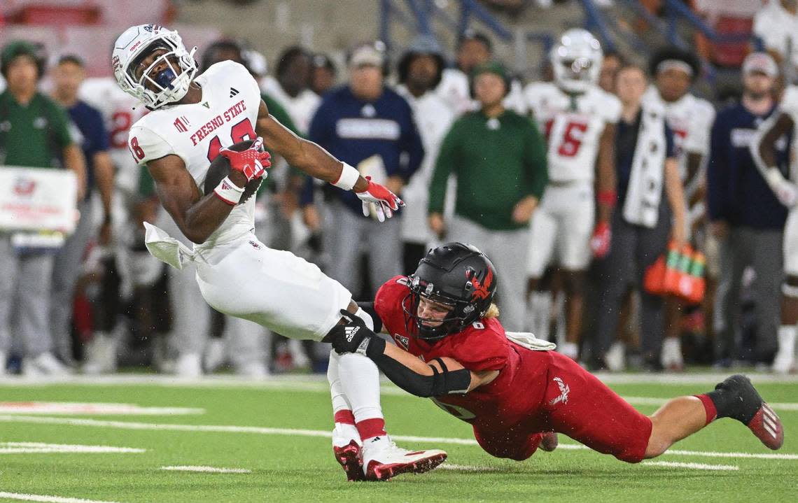 Fresno State’s Jalen Moss tries to spin away from Eastern Washington’s Jaren Banks after a catch in the second half of their game at Valley Children’s Stadium on Saturday, Sept. 9, 2023.