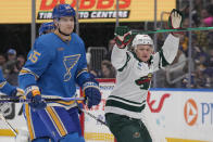 Minnesota Wild's Kirill Kaprizov, right, celebrates after scoring as St. Louis Blues' Colton Parayko (55) stands by during the third period of an NHL hockey game Saturday, March 16, 2024, in St. Louis. (AP Photo/Jeff Roberson)