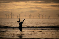 <p>A young girl dances and runs in the sea as she and her family celebrate Eid Al-Adha by watching the sunset at Crosby beach on August 21, 2018 in Liverpool, England. The traditional four-day celebratory festival marks one of the holiest days in the Islamic religious calendar. (Photo by Christopher Furlong/Getty Images) </p>