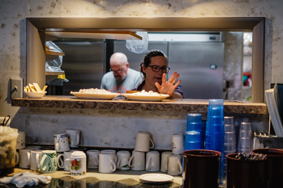 Stacy Hostettler, a line cook at Rosalie's Restaurant in Strasburg, puts an order into the service window.