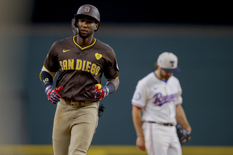 San Diego Padres' Jurickson Profar, left, rounds third base after hitting a home run during the sixth inning of a baseball game against the Texas Rangers, Thursday, July 4, 2024, in Arlington, Texas. (AP Photo/Gareth Patterson)