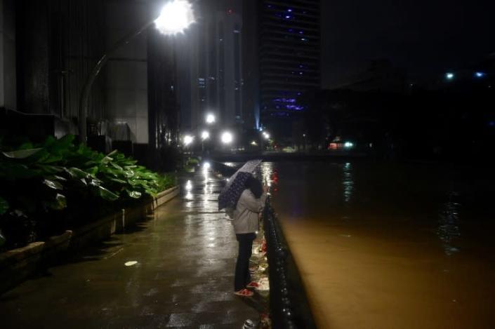 Downpours in Malaysia have caused rivers to overflow, submerging many urban areas and cutting off major roads (AFP/Arif Kartono)