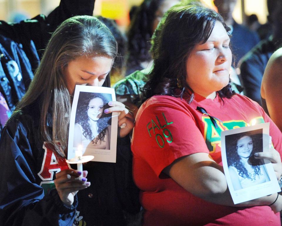 Mourners observe a moment of silence in memory of Faith Danielle Hedgepeth Monday, Sept. 10, 2012, during a celebration of life, at the University of North Carolina at Chapel Hill, N.C.