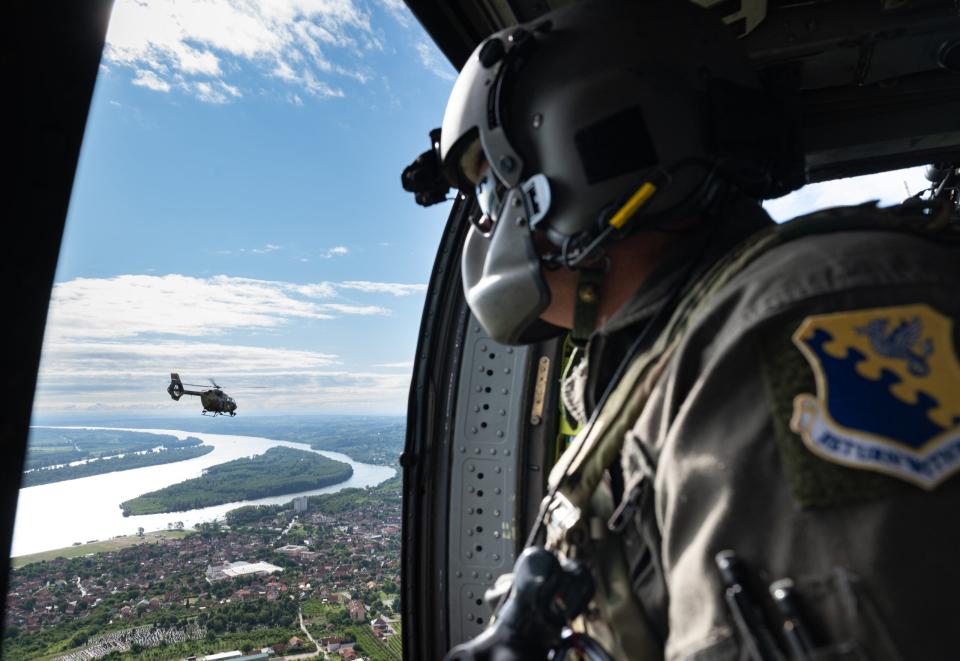 U.S. Air Force Master Sgt. Tyler Peterson, 31st Operations Wing standards and evaluations section chief, looks out at a Serbian Air Forc H145M helicopter during a formation flight while flying over Serbia, Aug. 8, 2023. <em>U.S. Air Force photo by Airman 1st Class Edgar Grimaldo</em><br>