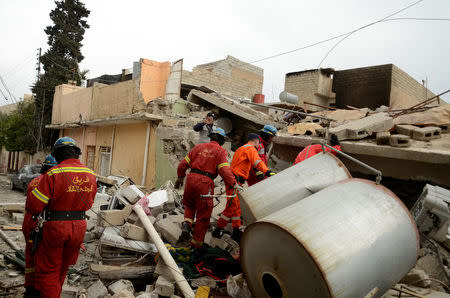 Firefighters search for the bodies of civilians who were killed after an air strike against Islamic State triggered a massive explosion in Mosul, Iraq, March 22, 2017. Picture taken March 22, 2017. REUTERS/Stringer