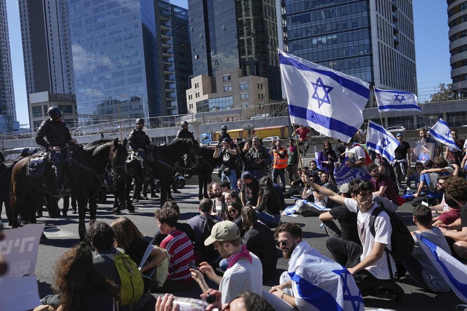 Mounted police are deployed as Israelis block a highway to protest against plans by Prime Minister Benjamin Netanyahu's government to overhaul the judicial system, in Tel Aviv, Israel, Thursday, March 9, 2023. (AP Photo/Ohad Zwigenberg)