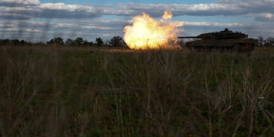 Ukrainian soldiers shoot from a tank