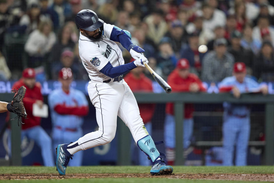 Seattle Mariners right fielder Teoscar Hernandez hits a two-run home run off St. Louis Cardinals starting pitcher Miles Mikolas during during the sixth inning of a baseball game Saturday, April 22, 2023, in Seattle. (AP Photo/John Froschauer)