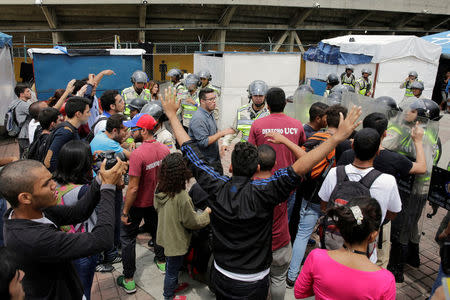 Demonstrators shout slogans in front of riot police during a student rally demanding a referendum to remove Venezuela's President Nicolas Maduro in Caracas, Venezuela October 24, 2016. REUTERS/Marco Bello