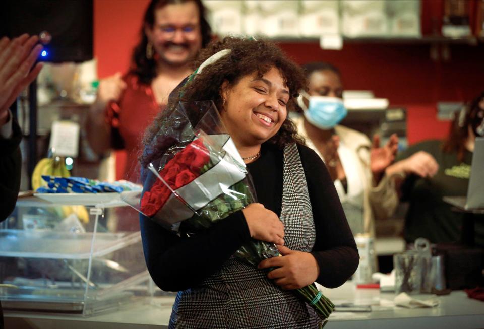 Des Moines City Council candidate Indira Sheumaker holds a bouquet of roses at her election watch party at Mars Cafe on University Avenue in Des Moines on Tuesday, Oct. 2, 2021, after beating incumbent Bill Gray.