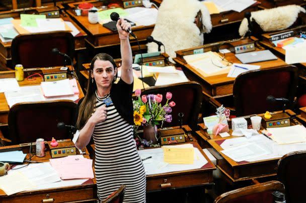 PHOTO: Rep. Zooey Zephyr stands in protest as demonstrators are arrested in the house gallery in the Montana State Capitol, April 24, 2023. (Thom Bridge/Independent Record via AP)