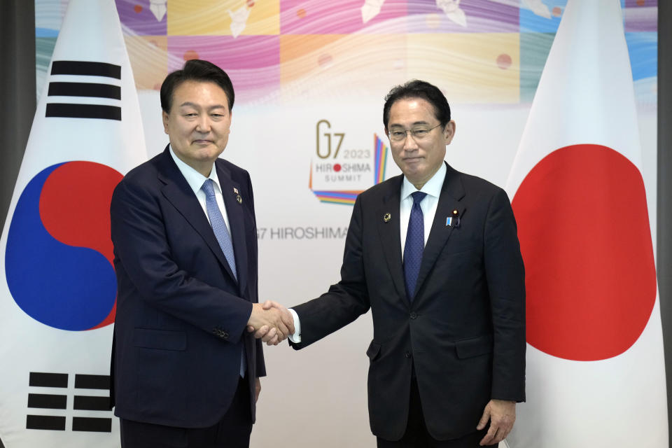 Japan's Prime Minister Fumio Kishida and South Korean President Yoon Suk Yeol shake hands during their bilateral meeting at the International Conference Center Hiroshima (ICCH) at the Group of Seven (G7) nations' meetings Sunday, May 21, 2023, in Hiroshima, western Japan. (AP Photo/Hiro Komae, Pool)