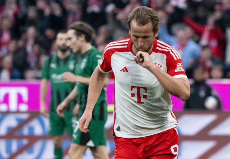 Munich's Harry Kane celebrates scoring his side's second goal during the German Bundesliga soccer match between Bayern Munich and Borussia Moenchengladbach at the Allianz Arena. Sven Hoppe/dpa