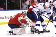 Florida Panthers goaltender Spencer Knight, left, goes against Tampa Bay Lightning left wing Pat Maroon (14) as he stops a shot on the goal during the first period in Game 5 of an NHL hockey Stanley Cup first-round playoff series, Monday, May 24, 2021, in Sunrise, Fla. (AP Photo/Lynne Sladky)