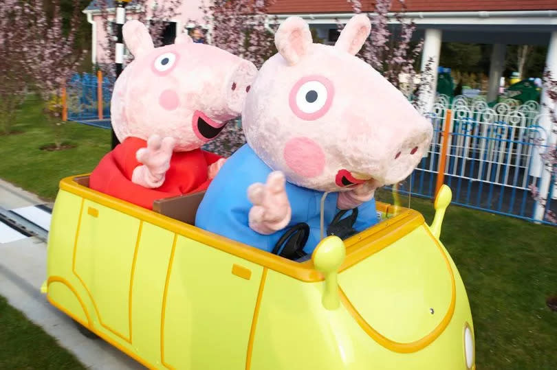 Characters George and Peppa on one of the rides at Peppa Pig World -Credit:Guildford Titles