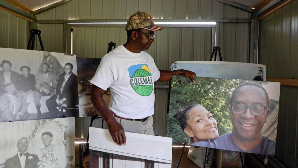 Jim Coleman organizes pictures of his family, including one of him and his wife Cathy who passed away in April 2020.