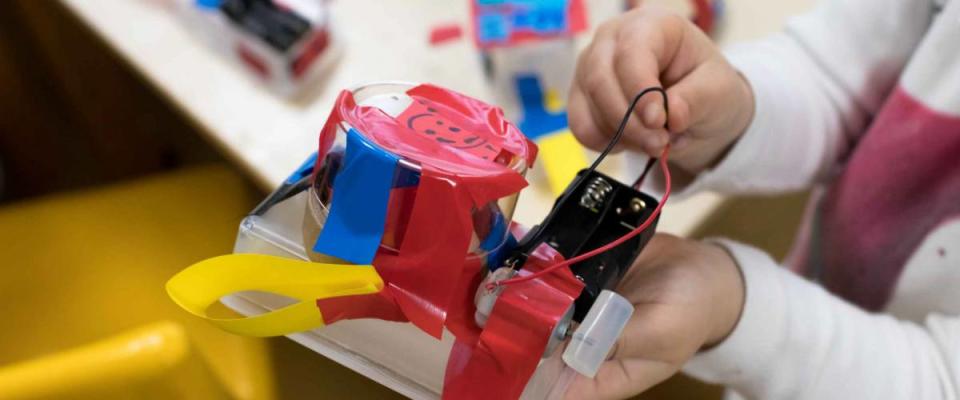 Construction of children's robots. Colored boxes with paper strips, inventions and creativity for children. Trash Robots, Tinkering and making, educational activities for schools and children