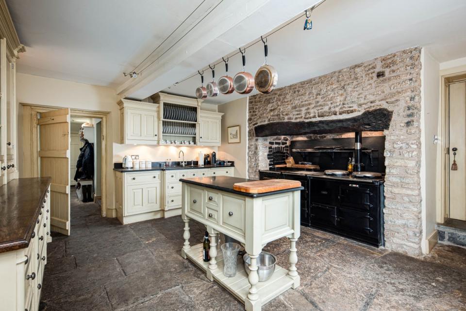 The kitchen has an Aga, stone walls and stone floors (Fine & Country)