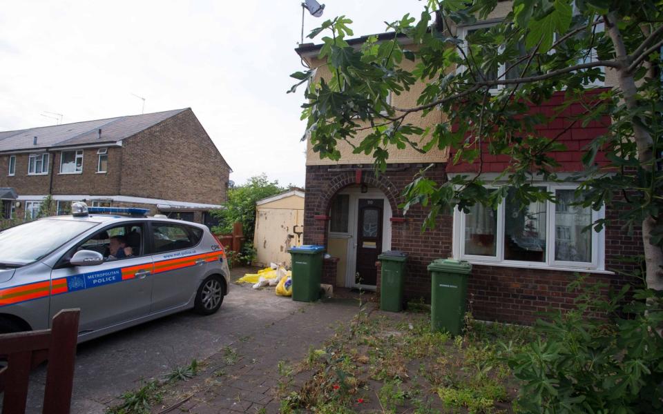 Police at the property where a body was found in a back garden - Jamie Lorriman