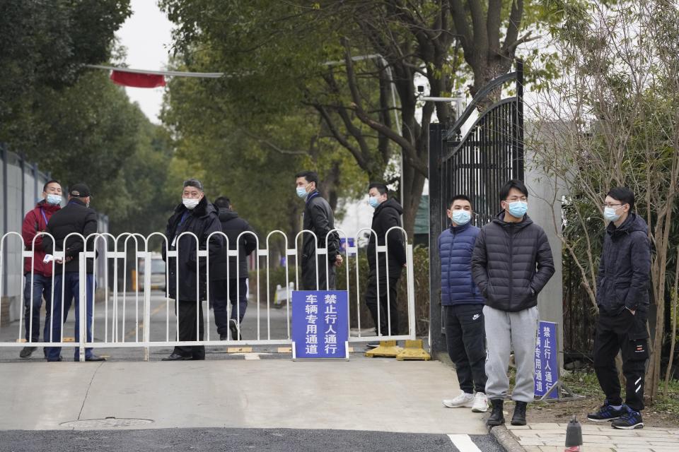 Security personnel guard an entrance to the Wuhan Jinyintan Hospital where a team from the World Health Organization visited in Wuhan in central China's Hubei province on Saturday, Jan. 30, 2021. (AP Photo/Ng Han Guan)