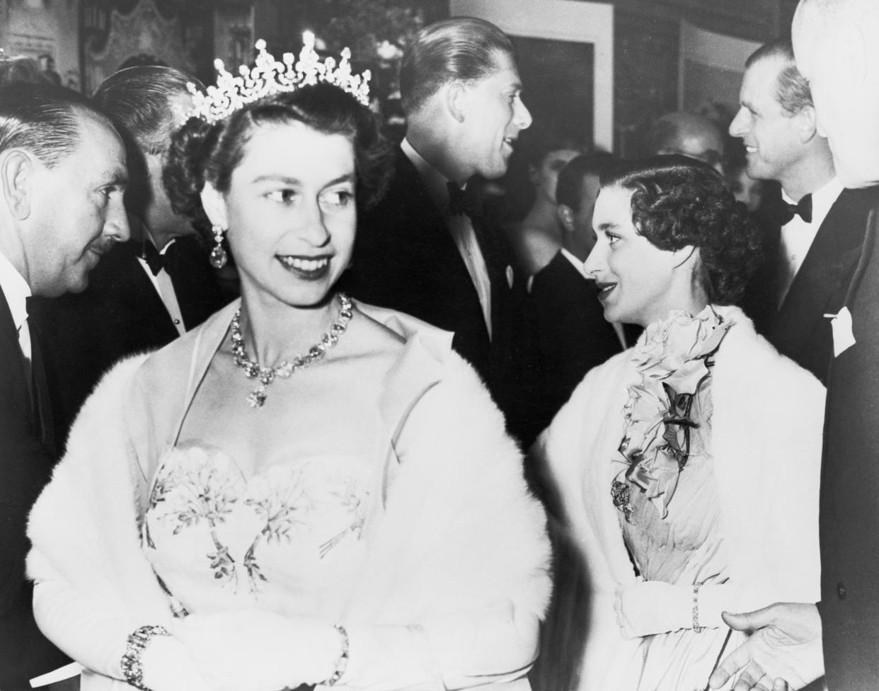 (Original Caption) Her Majesty the Queen with Princesa Margarita and the Duke of Edinburgh at Tivoli Theater. The Duke is conversing with Lord Harewood.