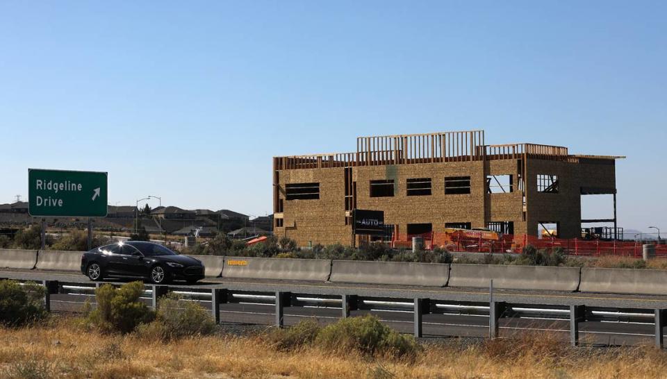 Traffic on Highway 395 in Kenewick passes by the new Alvarez Auto Sales building under construction in the Southridge area. The new car dealership is at 3809 Plaza Way in Kennewick.. The project includes ample parking for visitors as well as the inventory of vehicles for sale, along with a 4,054-square-foot office and service building.