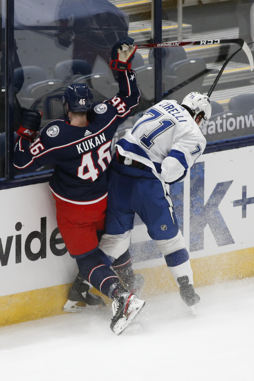 Tampa Bay Lightning's Anthony Cirelli, right, checks Columbus Blue Jackets' Dean Kukan during the second period of an NHL hockey game Thursday, Jan. 21, 2021, in Columbus, Ohio. (AP Photo/Jay LaPrete)