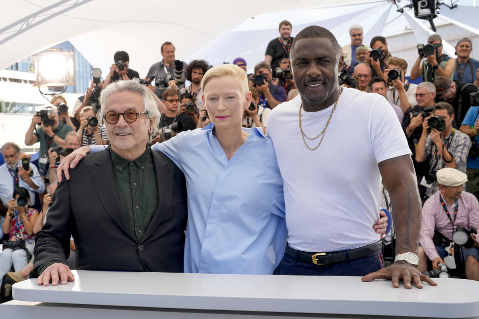 Director George Miller, from left, Tilda Swinton, and Idris Elba pose for photographers at the photo call for the film 'Three Thousand Years of Longing' at the 75th international film festival, Cannes, southern France, Saturday, May 21, 2022. (AP Photo/Petros Giannakouris)