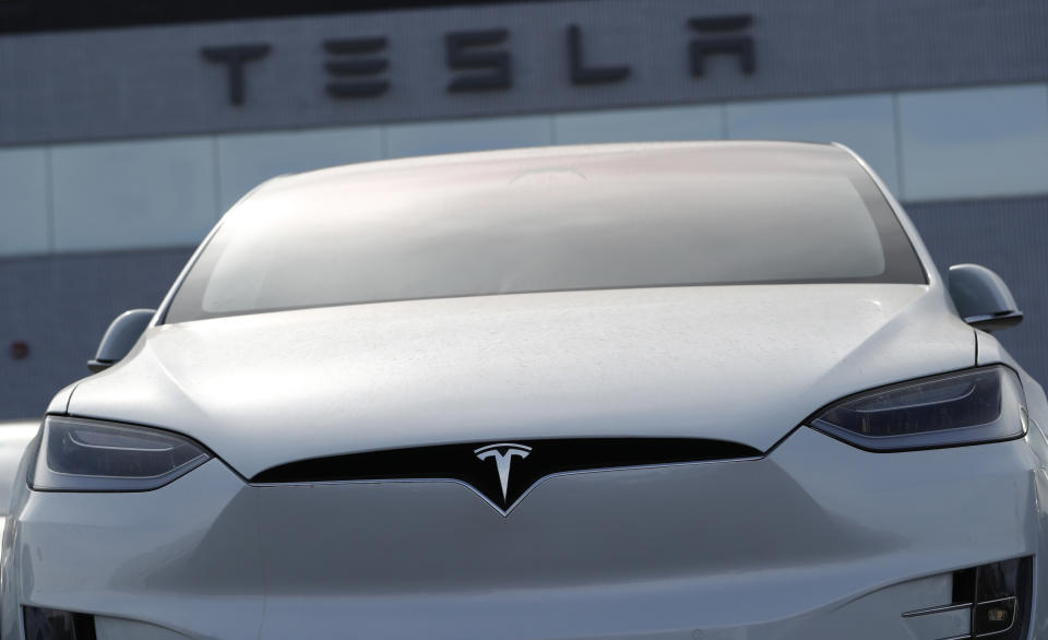 FILE-In this April 15, 2018, file photo, an unsold 2018 Model X 100d sits on a Tesla dealer's lot in the south Denver suburb of Littleton, Colo. Tesla reports earnings on Wednesday, April 19, 2023. (AP Photo/David Zalubowski, File)
