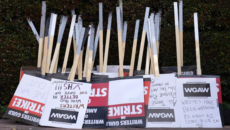 Placards are gathered together at the close of a picket by members of The Writers Guild of America outside Walt Disney Studios, Tuesday, May 2, 2023, in Burbank, Calif. On Sunday, Sept. 24, 2023, a tentative deal was reached to end Hollywood’s writers strike after nearly five months. 