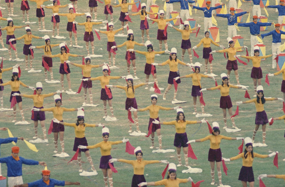 File - Iranian women take part during the celebrations to mark the 2,500 anniversary of the founding of the Persian Empire, young people in costume participate in parade for visiting dignitaries at Persepolis Iran, October 13, 1971. Iran's Islamic Republic requires women to cover up in public. But many Iranian women have long played a game of cat-and-mouse with authorities as a younger generation wears their veils more loosely or skirts requirements for conservative dress. (AP Photo/Horst Faas, File)