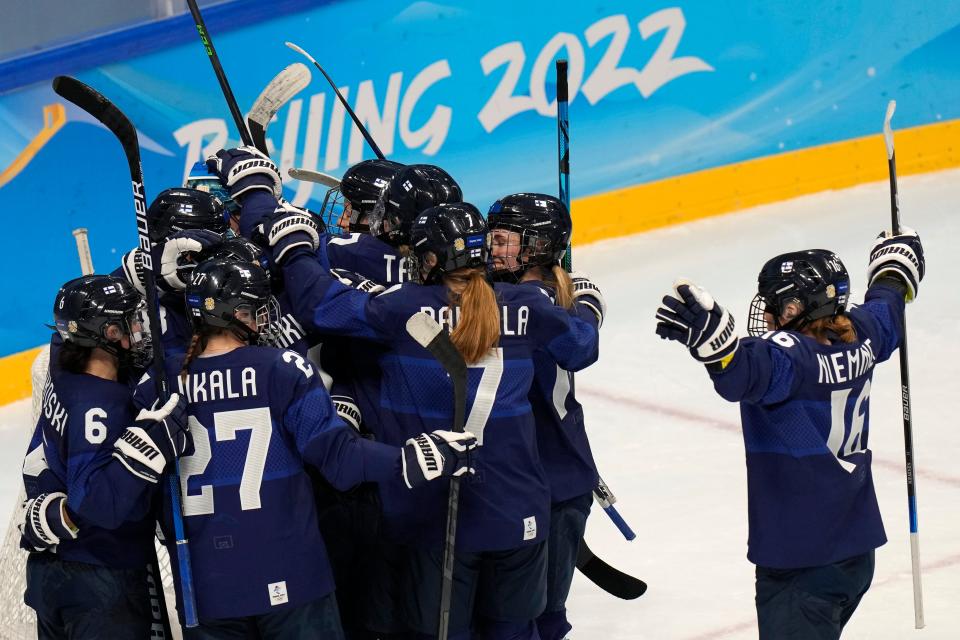 Finland celebrate winning their match against Japan (AP)