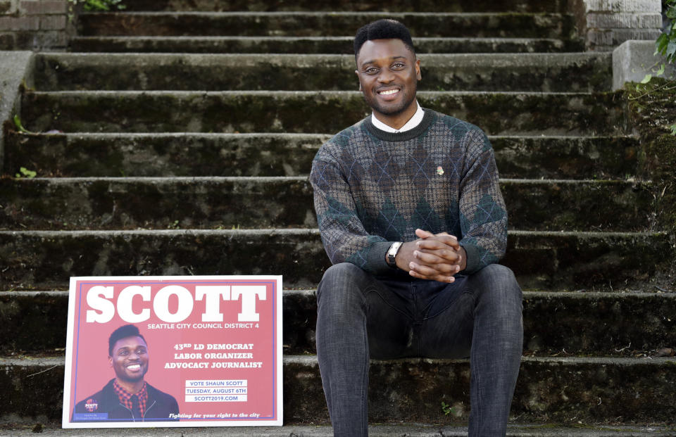 In this photo taken Monday, June 10, 2019, Seattle City Council candidate Shaun Scott, who describes himself as a democratic socialist, poses for a photo in Seattle. A first-of-its-kind public campaign finance program in Seattle gives voters vouchers worth $100 to pass on to any candidate they want. Now in its second election cycle, advocates say the program can level the political playing field, although its first round in Seattle showed mixed results. (AP Photo/Elaine Thompson)