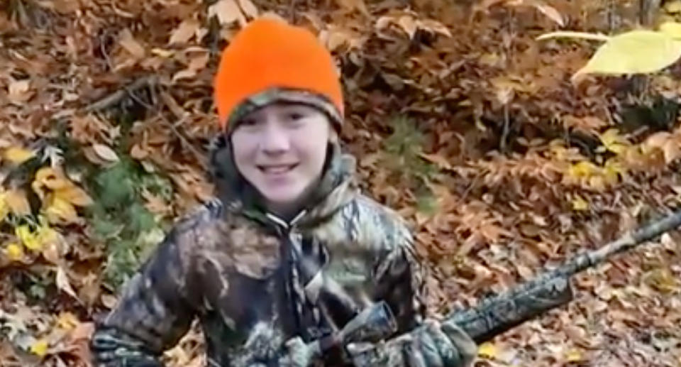 Caden Cotnoir wears camouflage and holds a gun. 