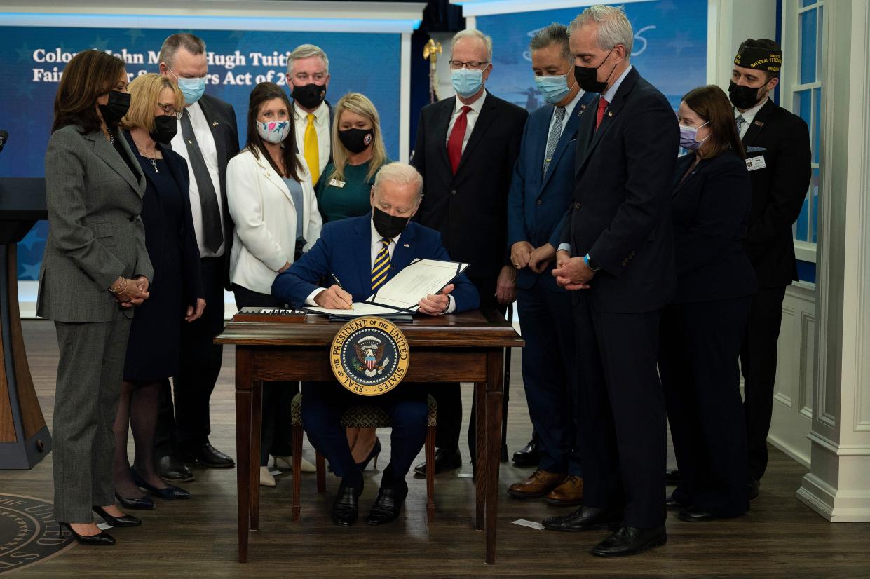 U.S. President Joe Biden signs S. 1095, Colonel John M. McHugh Tuition Fairness for Survivors Act of 2021, at the White House in Washington, DC on Nov. 30, 2021.