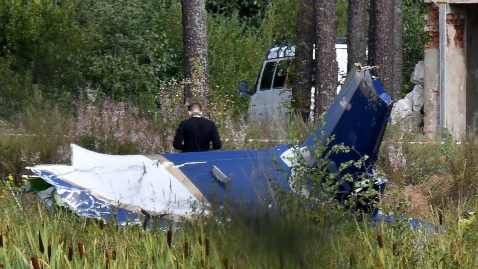 PHOTO: In this Aug. 24, 2023, file photo, a law enforcement officer works at the site of a plane crash near the village of Kuzhenkino, Tver region, (AFP via Getty Images, FILE)