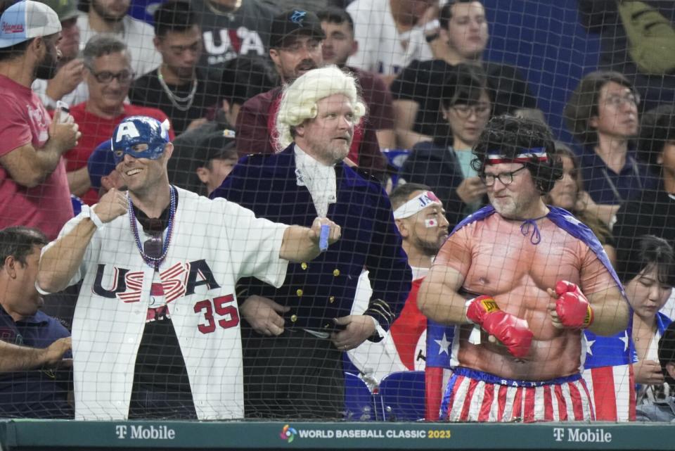 Fans cheer during the fourth inning of