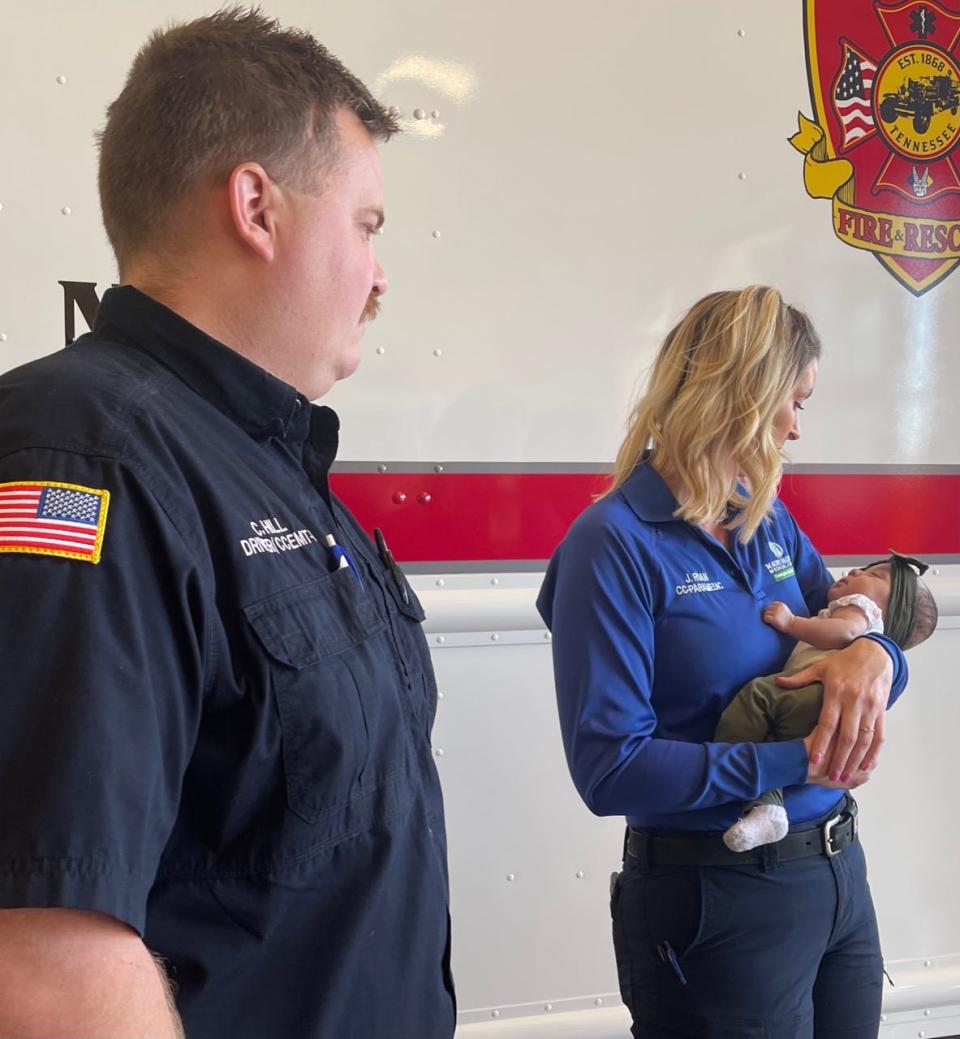 Newborn Za&#x002019;Myla Camilla Miracle Garrett is held by her Godmother Maury Regional EMS Paramedic Jamie Roan, as her Godfather Columbia firefighter and paramedic Cody Hill  Columbia, stands close, at  Fire &amp; Rescue Station 3 in Columbia, Tenn., on Tuesday, March 1, 2022.