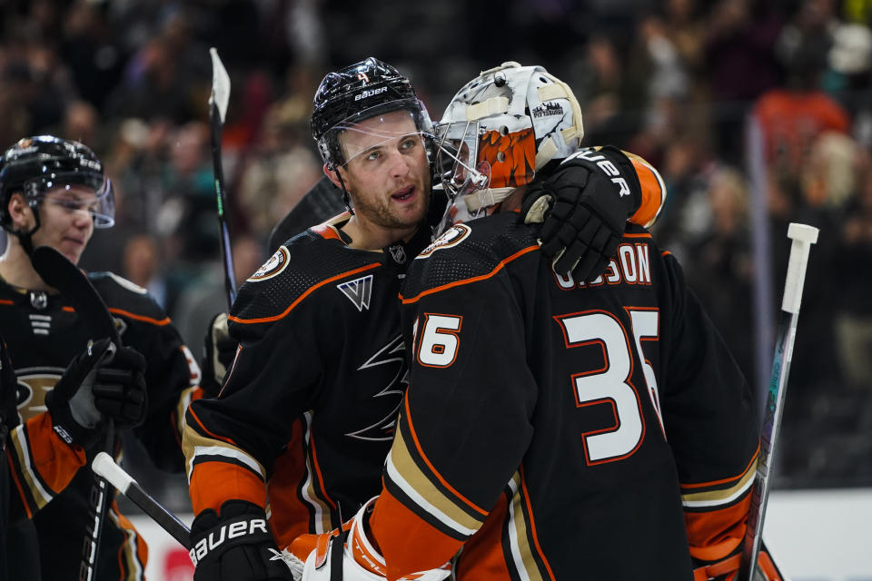 Anaheim Ducks goaltender John Gibson, right, is congratulated by defenseman Cam Fowler after the team's shootout win over the Colorado Avalanche in an NHL hockey game Saturday, Dec. 2, 2023, in Anaheim, Calif. (AP Photo/Ryan Sun)