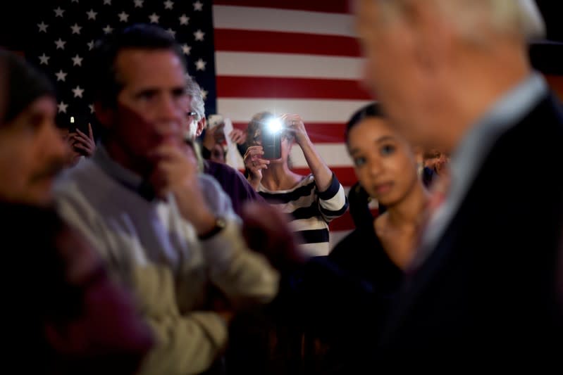 A woman photographs Democratic presidential candidate and former Vice President Joe Biden as he greets supporters after speaking in Scranton