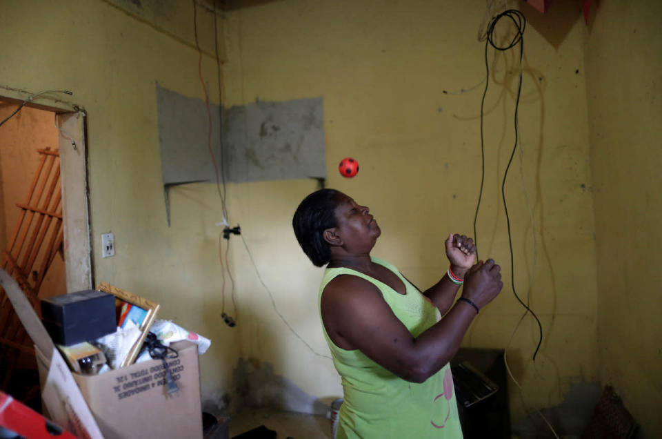 <p>Sandra Regina, 53, who has lived in the Vila Autodromo slum for 20 years with her children, plays with a ball as the family moves to one of the twenty houses built for the residents who refused to leave the community, in Rio de Janeiro, Brazil, August 1, 2016. (REUTERS/Ricardo Moraes)</p>