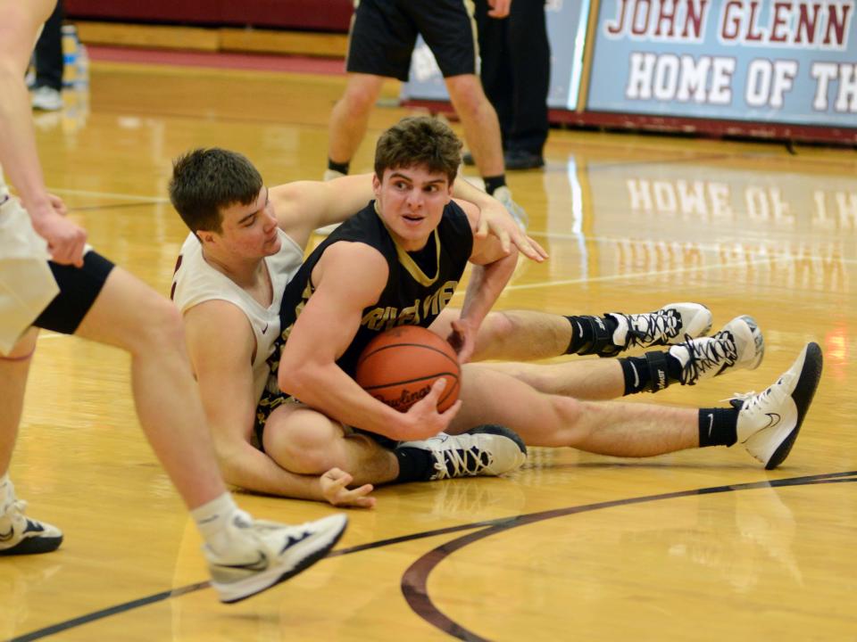 Nathan Larrick, left, of John Glenn, and River View's Carter Fry fight for a loose ball on Tuesday night in New Concord.