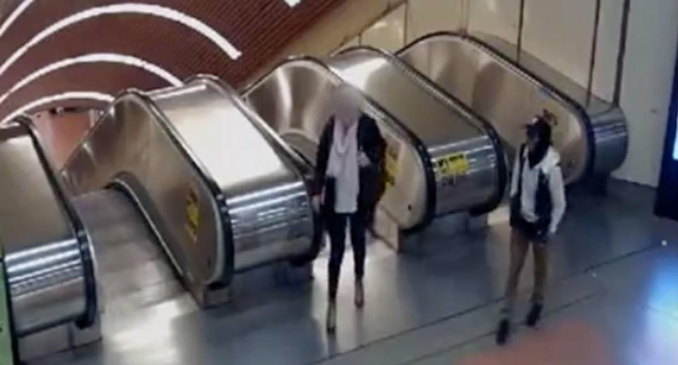 The man can be seen intently watching the woman as she made her way out of the station. Source: Victoria Police