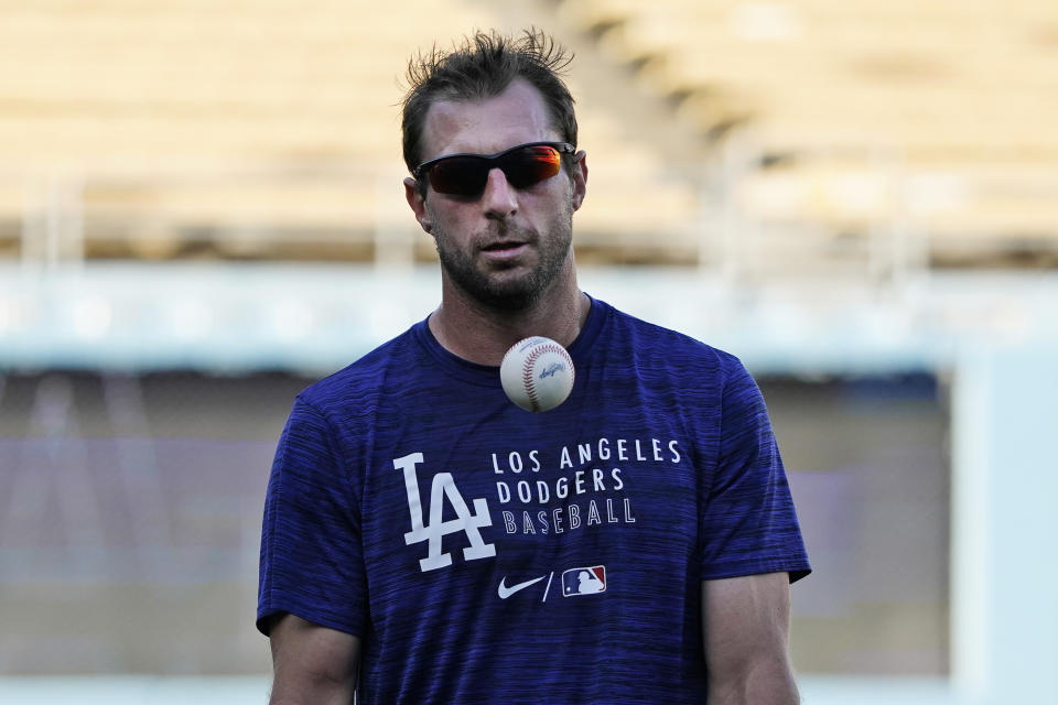 Los Angeles Dodgers starting pitcher Max Scherzer juggles a baseball during a workout ahead of Game 3 of baseball's National League Championship Series against the Atlanta Braves, Monday, Oct. 18, 2021, in Los Angeles. (AP Photo/Marcio Jose Sanchez)