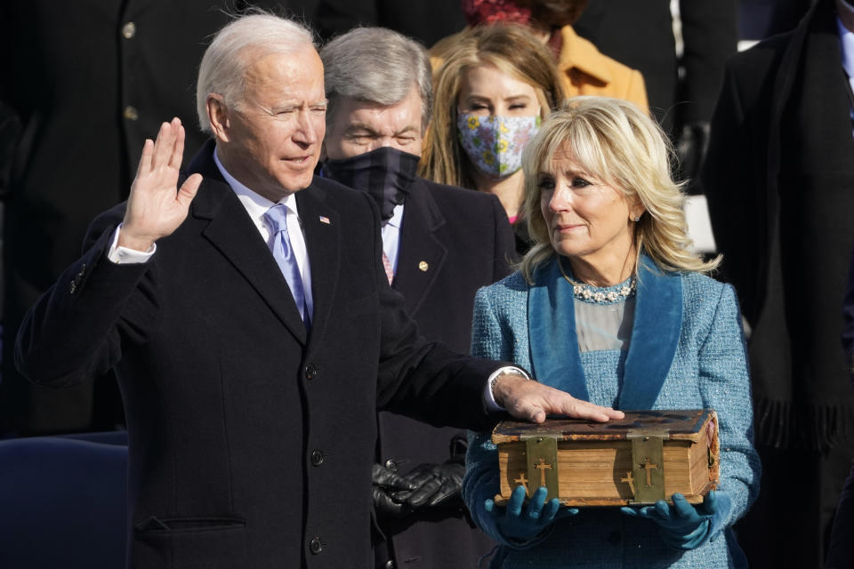 Joe Biden is sworn in as the 46th president of the United States as Jill Biden holds the Bible at the U.S. Capitol on Jan. 20, 2021. (Photo: AP Photo/Andrew Harnik)