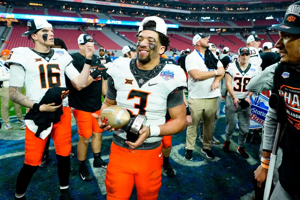 Oklahoma State quarterback Spencer Sanders (3) celebrates after beating Notre Dame 37-35 in the Fiesta Bowl on Jan. 1, 2022.