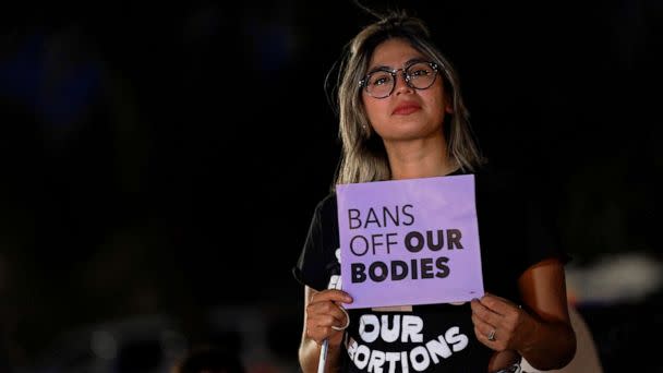 PHOTO: A woman protests outside the Arizona Capitol to voice her dissent with an abortion ruling, on Sept. 23, 2022, in Phoenix. (Matt York/AP)