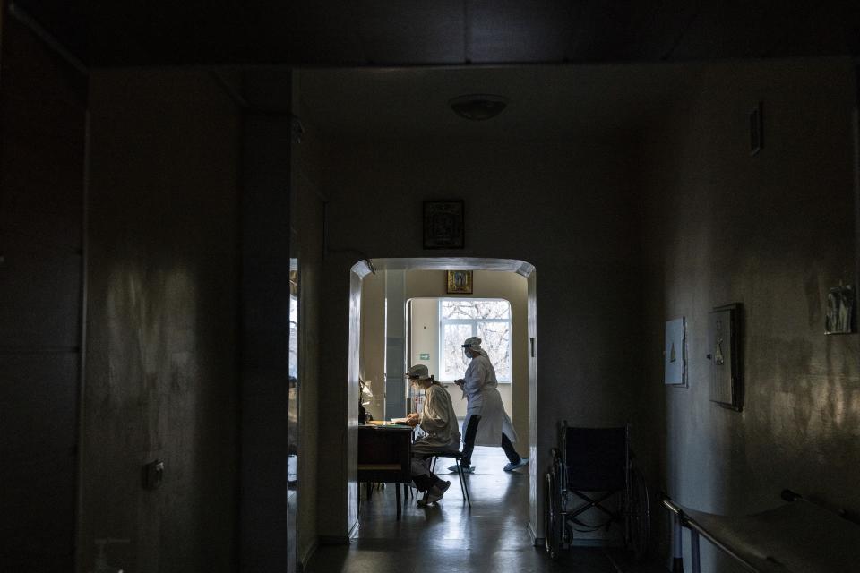 Olena Obyedko, 26-year-old nurse, wears protective clothing against coronavirus in the hospital for COVID-19 patients in the mining town of Selydove, 700 kilometers (420 miles) east of Kyiv, eastern Ukraine, Thursday, March 4, 2021. Obyedko works in the hospital's intensive-care ward for COVID-19 patients, where people die every week. But, she said, "I decided not to get vaccinated. I doubt the quality of the vaccine. I'm afraid there will be side effects." Ukrainians are becoming increasingly opposed to vaccination: an opinion poll this month by the Kyiv International Institute of Sociology found 60% of the country's people don't want to get vaccinated, up from 40% a month earlier. (AP Photo/Evgeniy Maloletka)