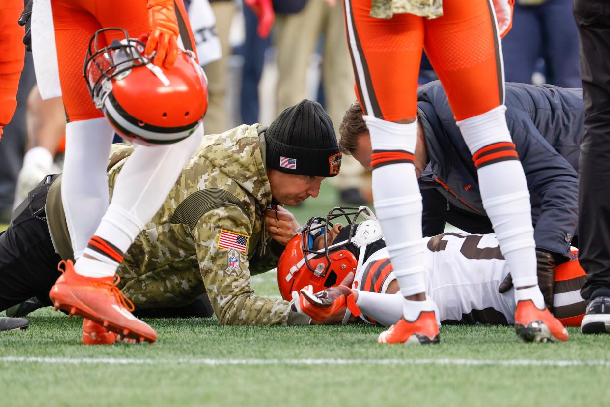 Cleveland Browns cornerback Troy Hill (23) is tended to by a medical trainer after an injury during the second half of an NFL football game against the New England Patriots, Sunday, Nov. 14, 2021, in Foxborough, Mass. (AP Photo/Greg M. Cooper)