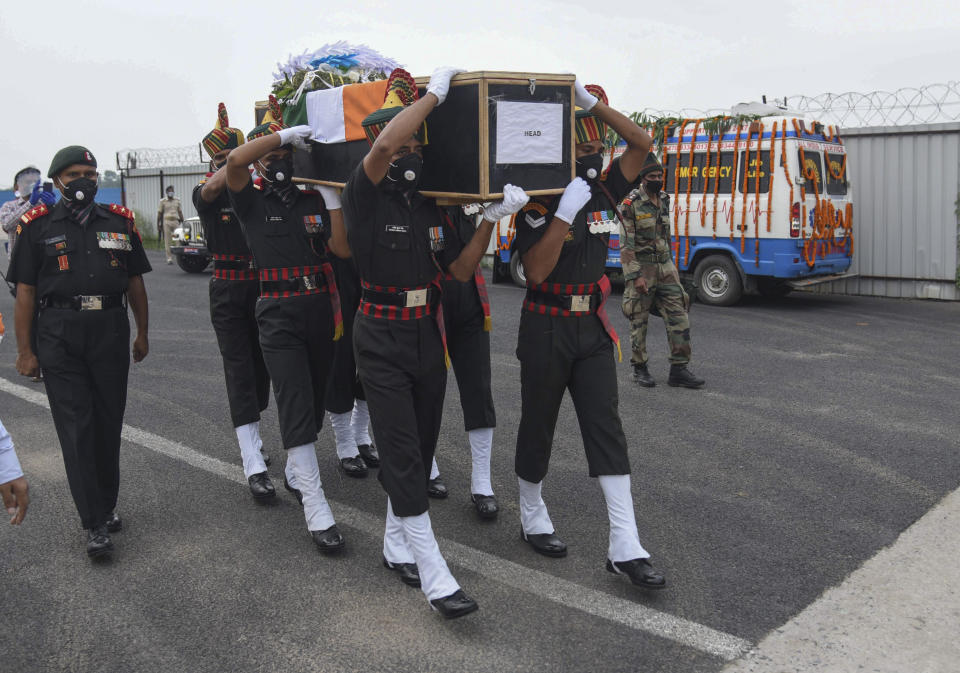 Indian army soldiers carry the coffin of their colleague Sunil Kumar, killed during confrontation with Chinese soldiers in the Ladakh region, as the body was brought to Jai Prakash Narayan airport, in Patna, Bihar state, India, Wednesday, June 17, 2020. Twenty Indian troops were reportedly killed, in the clash in the Ladakh region late Monday that was the first deadly confrontation on the disputed border between India and China since 1975. (AP Photo/Aftab Alam Siddiqui)